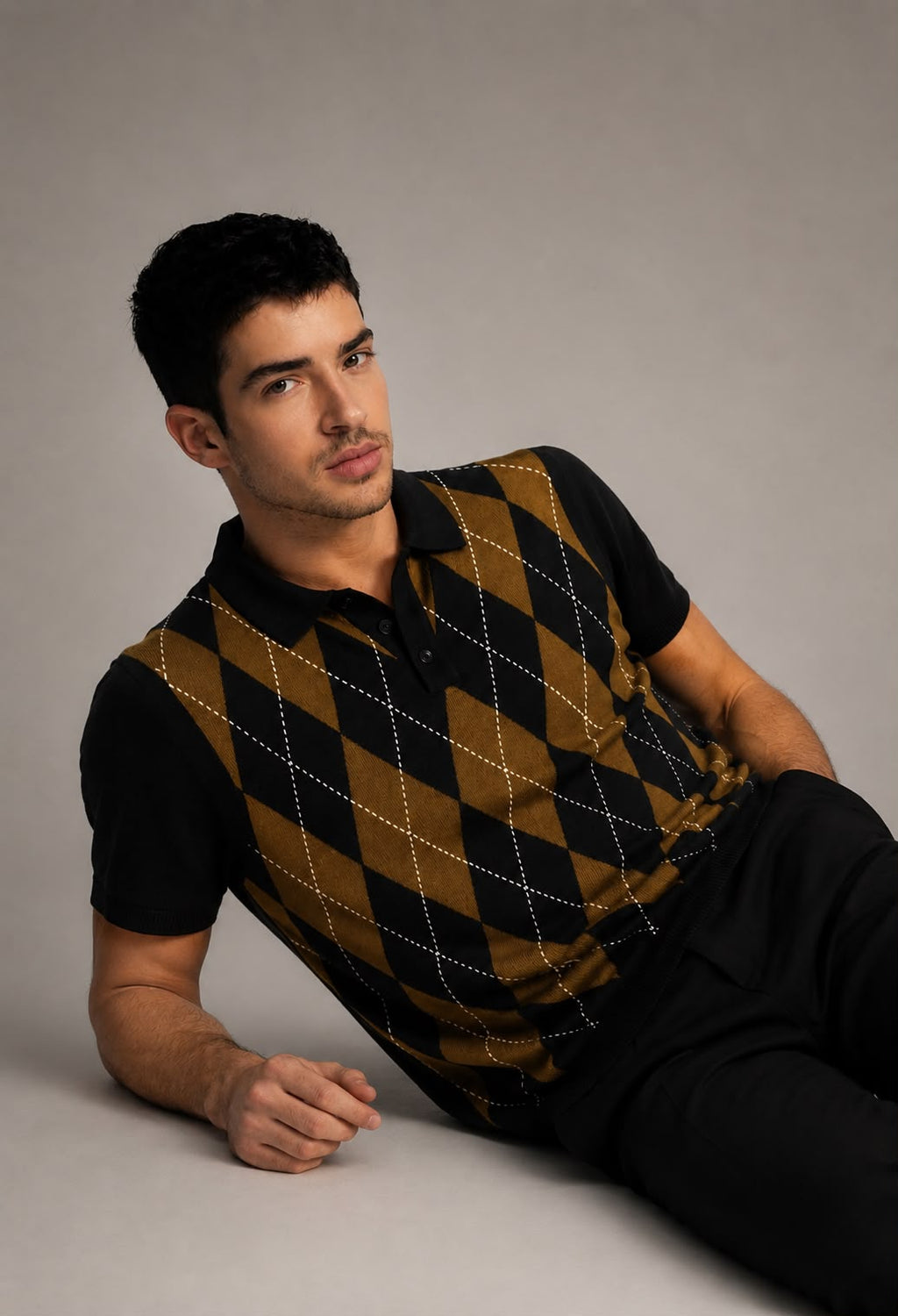 BEZOKE Black Olive Argyle Knit Polo — bold diamond argyle pattern in black and olive gold with white stitch lines
